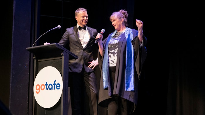 Tim Campbell and student at podium