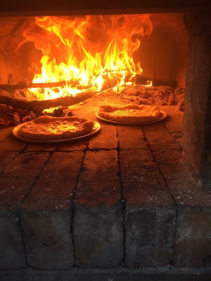 Eric Pizza 3 in a pizza oven