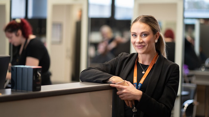 GOTAFE staff member leaning against counter