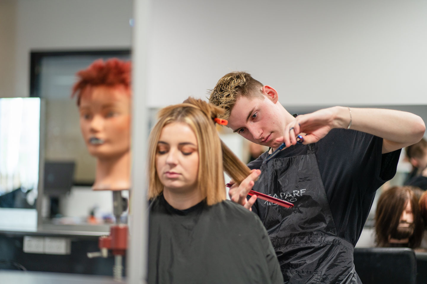 Student cutting customers hair in the wangaratta hair salon