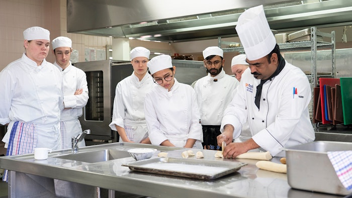 Training chefs around kitchen table