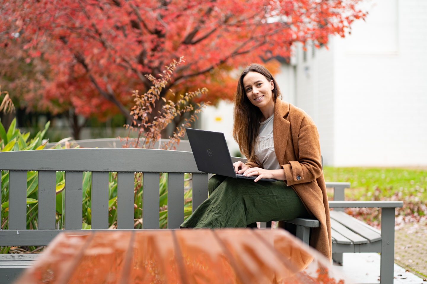 Woman showing another woman information booklet.