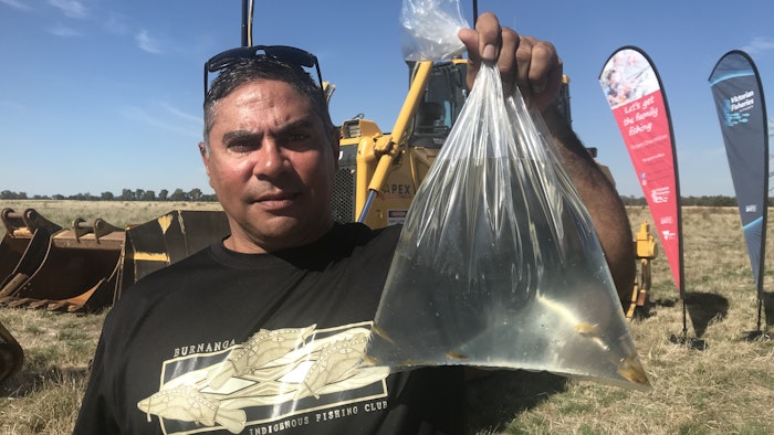 Man holding fish from hatchery release