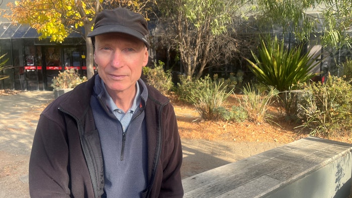 A man sitting on a bench seat.