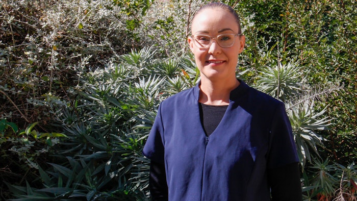 Mel Wilcox standing in front of garden