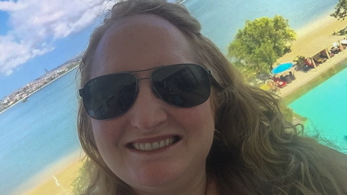 Melissa taking selfie on the beach during a self-care holiday.