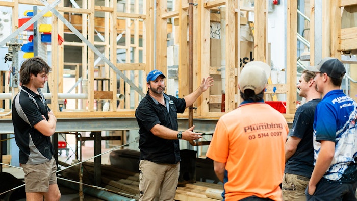 Apprentices standing in a job site talking