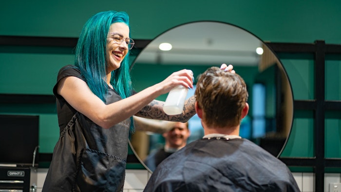 GOTAFE Hairdressing student Colouring a clients hair with a brush