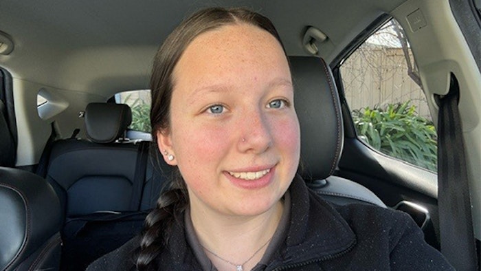 Tristan Andrew standing in workshop in front of tools