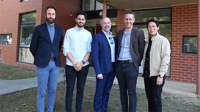 Tech School Director, Xavier Norden, standing with architects and DET staff