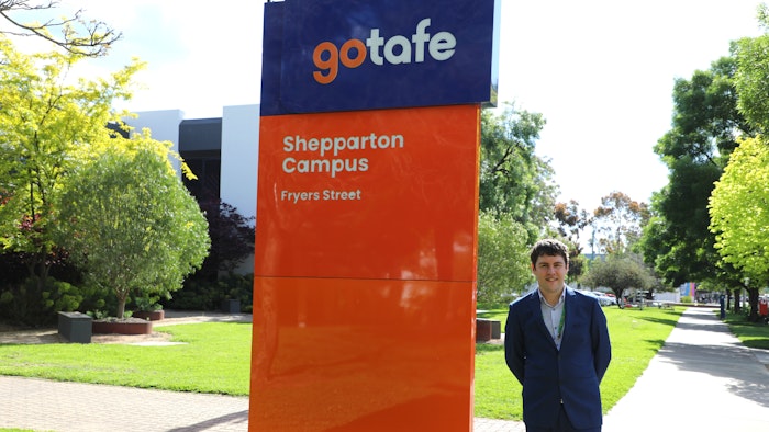 Person standing next to the Shepparton GOTAFE Campus Fryers Street sign.